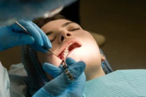 Dentist checking a patient's gums during a routine oral hygiene review
