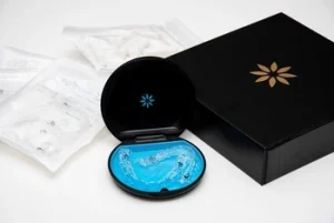 Clear aligner set resting in its storage kit