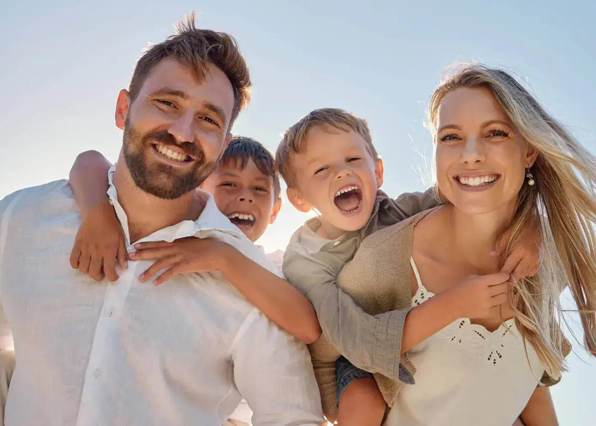 Child holding their cheek with a toothache while a parent comforts them