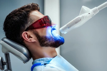 Whitening gel being applied during an in-chair teeth whitening procedure