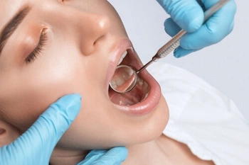 Dentist checking a patient's sensitive teeth during an examination