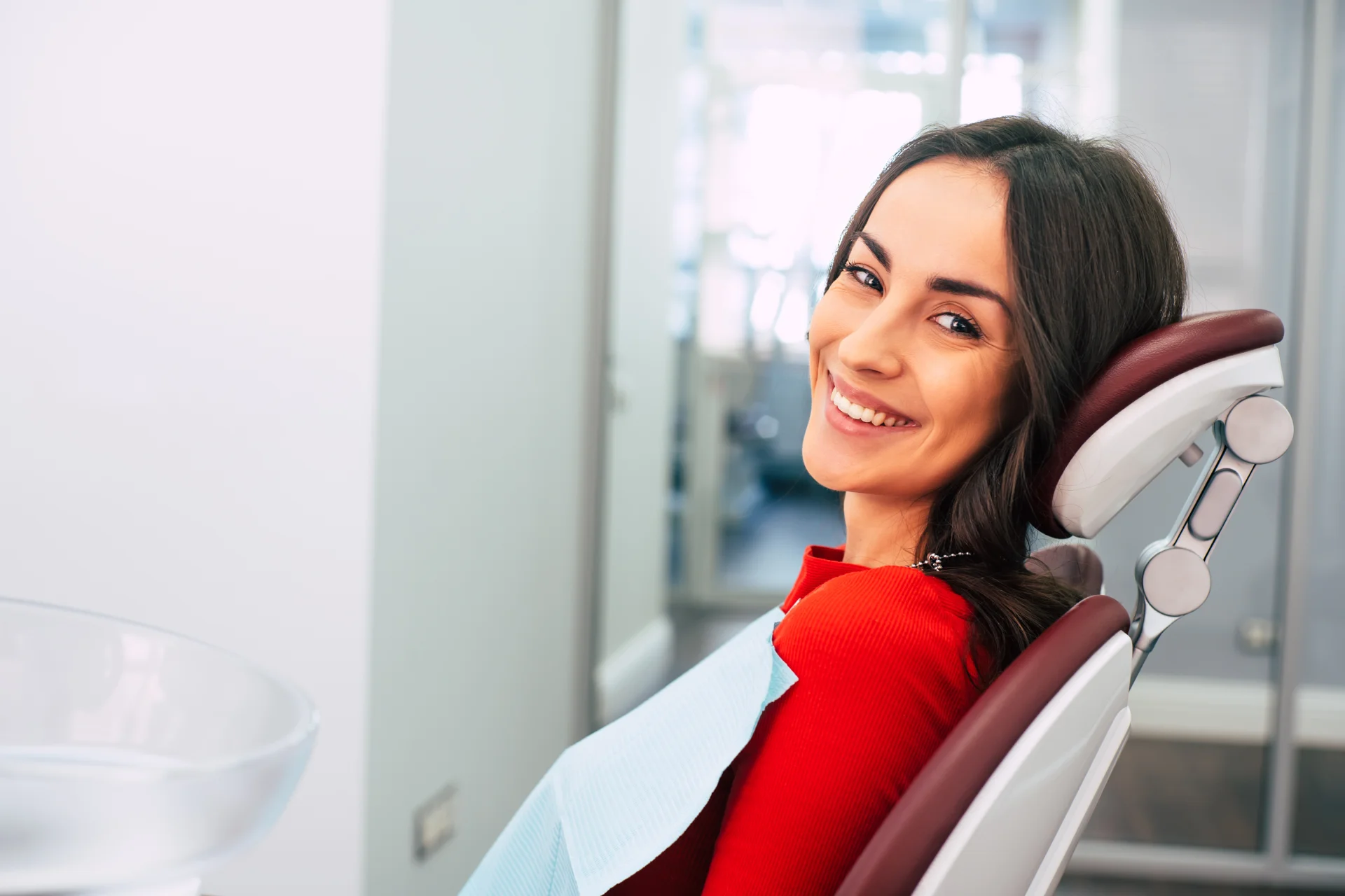 Smiling adult patient relaxed in a dental chair after a teeth straightening consultation