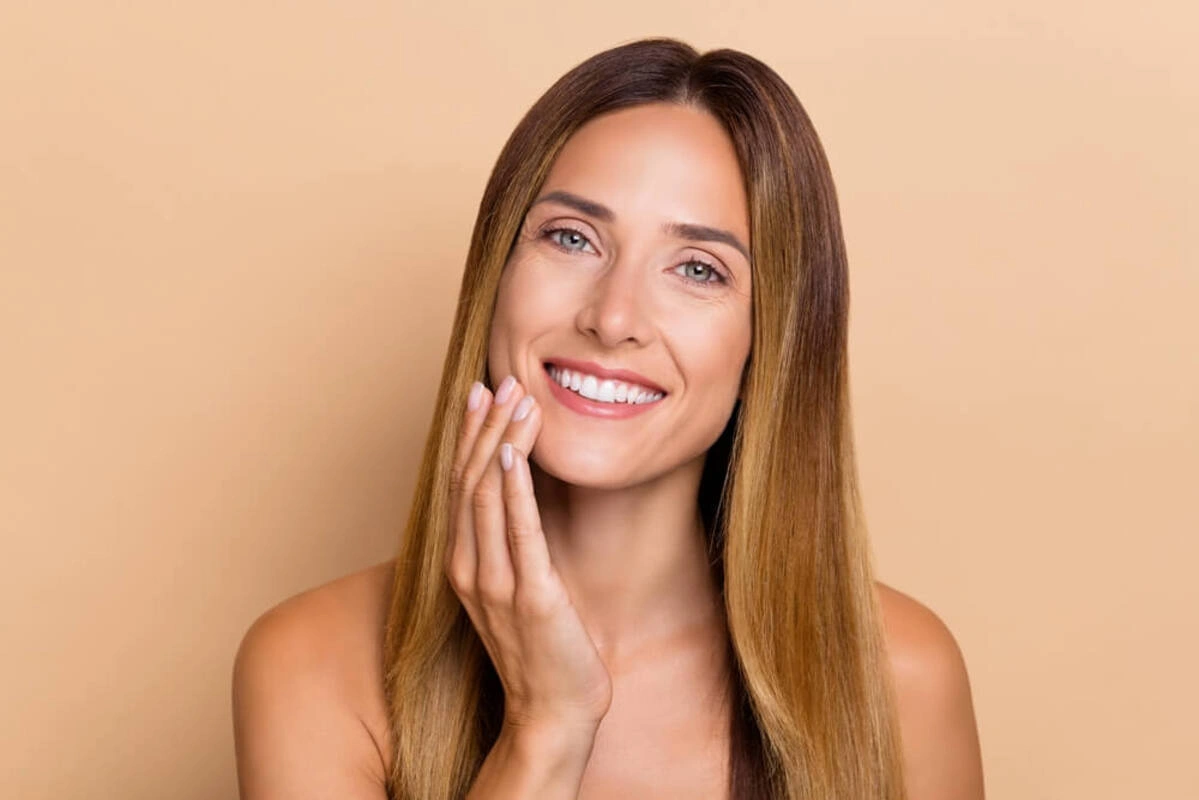 Person holding their cheek in discomfort from wisdom tooth pain